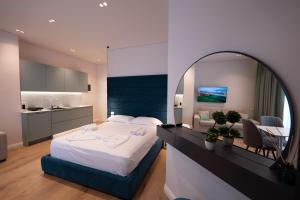a bedroom with a large bed and a mirror at Summer Depo in Sarandë