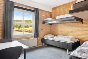 Voodi või voodid majutusasutuse Sæby Spektrum & Hostel toas