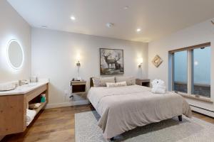 a bedroom with a large bed and a sink at Lion Square Lodge South 257 & 261 in Vail +26 photos