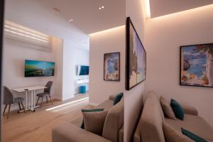 a living room with a couch and a table at Summer Depo in Sarandë