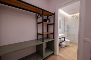 a bathroom with a closet with a sink and a toilet at Summer Depo in Sarandë +145 photos