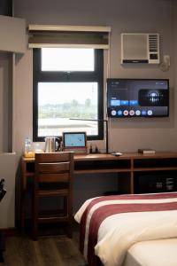 TV a/nebo společenská místnost v ubytování Kekehyu Business Hotel