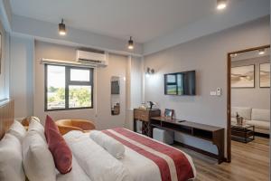 Postel nebo postele na pokoji v ubytování Kekehyu Business Hotel