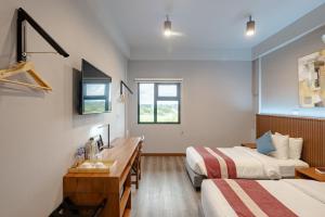 Postel nebo postele na pokoji v ubytování Kekehyu Business Hotel