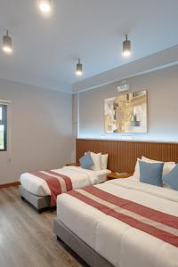 Postel nebo postele na pokoji v ubytování Kekehyu Business Hotel