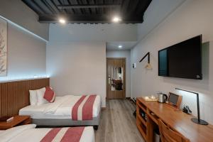 Postel nebo postele na pokoji v ubytování Kekehyu Business Hotel