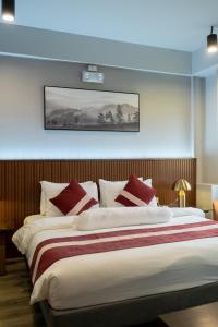 Postel nebo postele na pokoji v ubytování Kekehyu Business Hotel