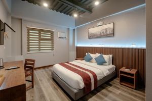 Postel nebo postele na pokoji v ubytování Kekehyu Business Hotel