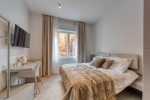 Postel nebo postele na pokoji v ubytování Santa Lucia Suites