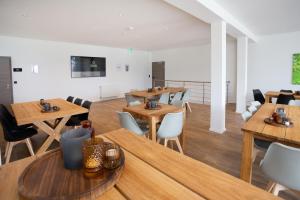 a dining room with wooden tables and chairs at Lieblingsquartier Sankt Andreasberg Studio 9 in Sankt Andreasberg
