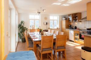 a kitchen and dining room with a table and chairs at Ferienhaus am Glockenberg in Sankt Andreasberg