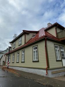 a large wooden house with a red roof at Haapsalu OldTown apartment in Haapsalu
