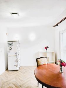a dining room with a table and a refrigerator at Appartement de 60m2 à 20 minutes de Paris in Montigny-lès-Cormeilles