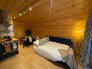 a bedroom with a bed in a wooden room at Isabels Cabin in Banavie