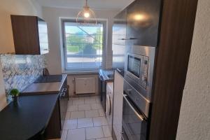 a kitchen with a sink and a stove top oven at Monteurwohnung in Marl - Schiller - 1OGR in Marl