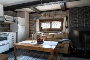 a living room with a couch and a table at Wood stove | Cross-country skiing trails in Lofsdalen