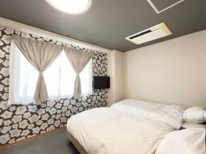 a bedroom with two beds and a window at Kyoto Jujo 01 京都十条 01 in Kyoto