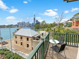 a building with a table and chairs on a balcony at Balmain Wharf l 2 Bedroom Apartment in Sydney