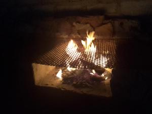 a fire in a brick oven with food in it at Matibidi Guest Lodge in Graskop