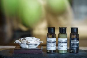 three bottles of essential oils sitting on a table at Return to Emei Hotel in Baoguosi