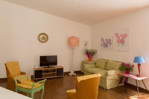 a living room with a couch and a tv at Hotiday Apartments Case Bianche in Orosei +49 photos