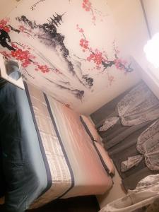 a room with two beds and a painting on the wall at BandK Kouenji in Tokyo