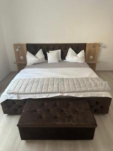 a large bed with white sheets and pillows at Aparthouse 1 in Lugoj