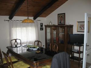 a dining room with a table and a television at Agriturismo Il Casotto in Maida