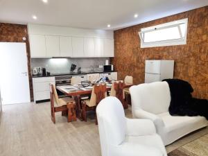 a kitchen and dining room with a table and chairs at Casa Caromba, Sunrise in Prazeres