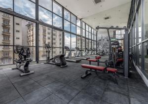 a gym with rows of tread machines in a building at Reizz Residence Majesty Suite in Kuala Lumpur