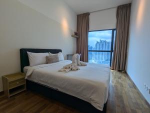 a bedroom with a large bed with a large window at Reizz Residence Majesty Suite in Kuala Lumpur +24 photos