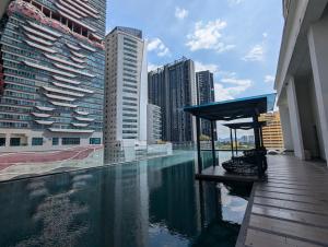 a swimming pool in a city with tall buildings at Reizz Residence Majesty Suite in Kuala Lumpur
