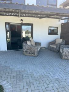 a patio with couches and chairs on a patio at 31Ridge Road in Durbanville +11 photos