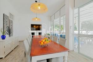 a dining room table with a bowl of fruit on it at Villa Bio Finca With Pool in Playa Paraiso