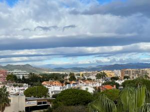 a city with buildings and mountains in the background at AGH Canet in Canet de Berenguer