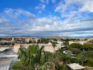 a view of a city with buildings and palm trees at AGH Canet in Canet de Berenguer