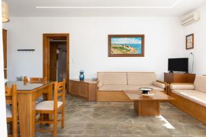 a living room with a couch and a table at Villa Christina 2 Kythnos in Mérikhas