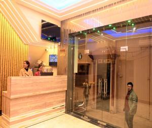 a group of people standing in a lobby at Hotel Shankara Residency in Varanasi