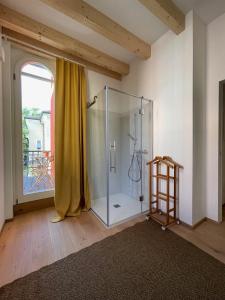a glass shower in a room with a window at Nine Rooms Double in Trento