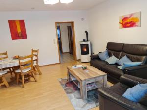 a living room with a couch and a table at Haus Poldi in Trassem