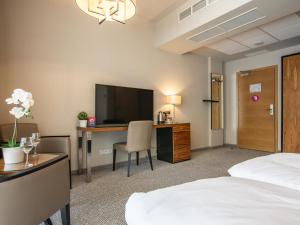 Televízia a/alebo spoločenská miestnosť v ubytovaní VacationClub - Diune Hotel Apartament 115