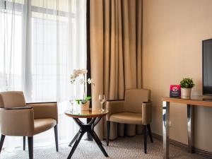 Televízia a/alebo spoločenská miestnosť v ubytovaní VacationClub - Diune Hotel Apartament 115