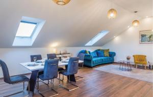 a living room with a table and chairs and a couch at 6 Bedroom Amazing Home In Bilice in Bilice