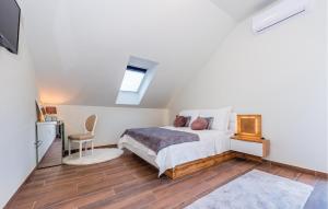 a white bedroom with a bed and a chair at 6 Bedroom Amazing Home In Bilice in Bilice