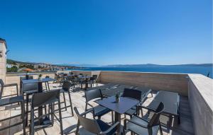 a patio with tables and chairs on a roof at Cozy Apartment In Crikvenica in Crikvenica +27 photos