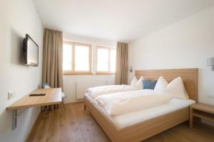 Ένα ή περισσότερα κρεβάτια σε δωμάτιο στο Gasthof Grünwald