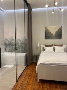 a bedroom with a bed and a bath tub at Apartamenty Warszawska in Toruń +64 photos