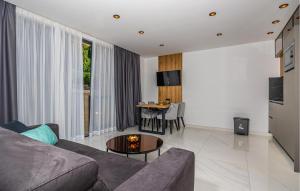 a living room with a couch and a table at Cozy Apartment In Crikvenica in Crikvenica