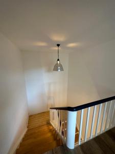 a hallway with a staircase with a pendant light at Lieblingsquartier komplett in Sankt Andreasberg