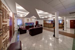 a large living room with couches and a tv at Country Club Aivengo Hotel Jungle in Podolsk